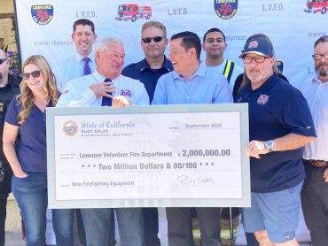Rudy Salas with Lemoore Fire Chief Bruce German and local officials and friends.